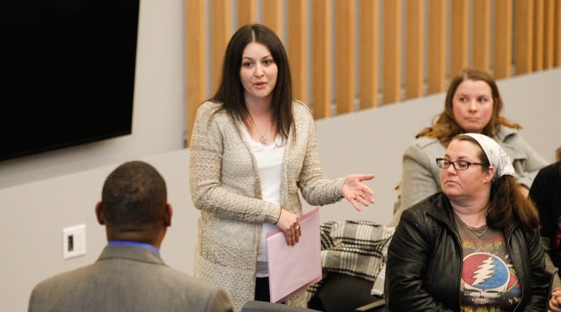 Stacey Brown of Dayton questions Montgomery County Administrator Michael Colbert at a presentation Tuesday given by a team reviewing the operations of the Montgomery County Animal Resource Center. CHRIS STEWART / STAFF