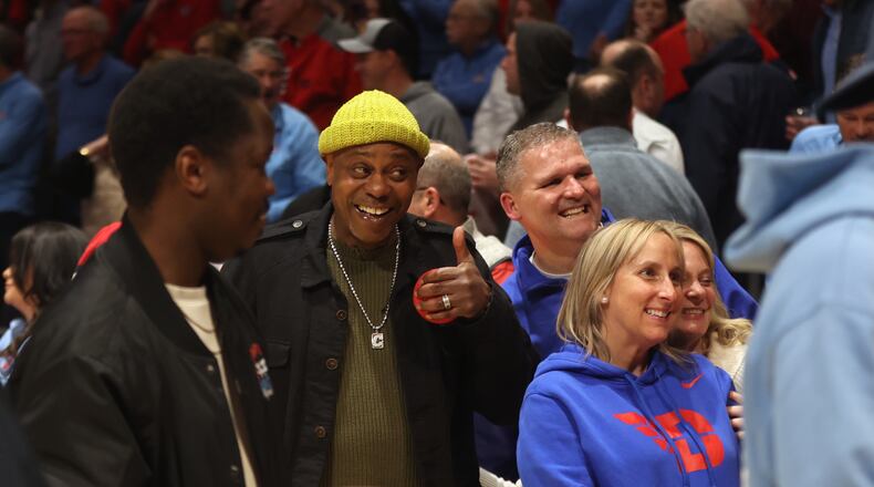 Comedian Dave Chappelle leaves the court after Dayton's victory against Saint Louis on Tuesday, March 4, 2025, at UD Arena. David Jablonski/Staff