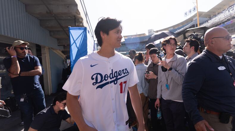 Los Angeles Dodgers two-way player Shohei Ohtani leaves after talking to reporters during DodgerFest at Dodger Stadium in Los Angeles, Saturday, Jan. 31, 2026. (AP Photo/Jae C. Hong)