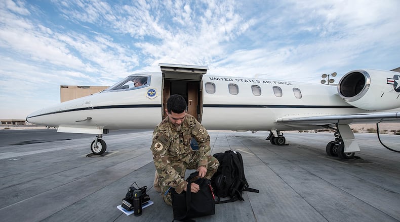 U.S. Air Force Capt. Ramiro Rios, a C-21 pilot assigned to the 746th Expeditionary Airlift Squadron, prepares for a flight at Al Udeid Air Base, Qatar, Feb. 7, 2018. (U.S. Air National Guard photos/Master Sgt. Phil Speck)