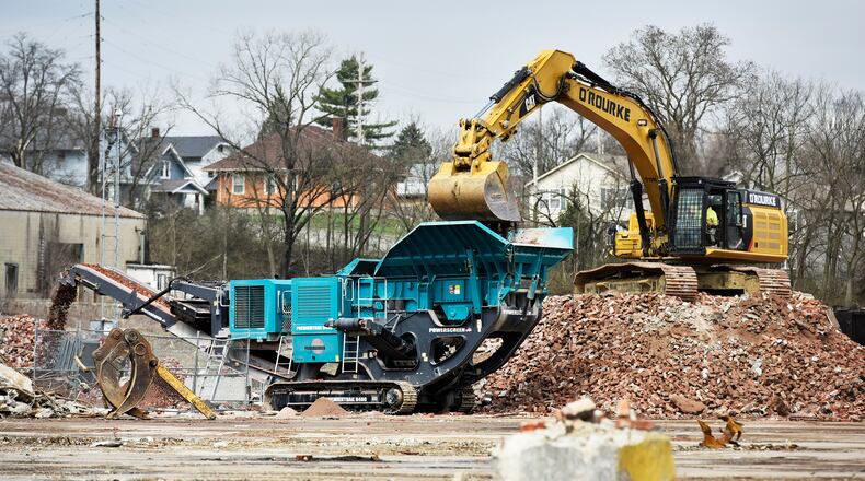 Crews load piles of bricks a machine to pulverize bricks at the former Champion Mill and future Spooky Nook Sports location on B Street Friday, April 5 in Hamilton. NICK GRAHAM/STAFF