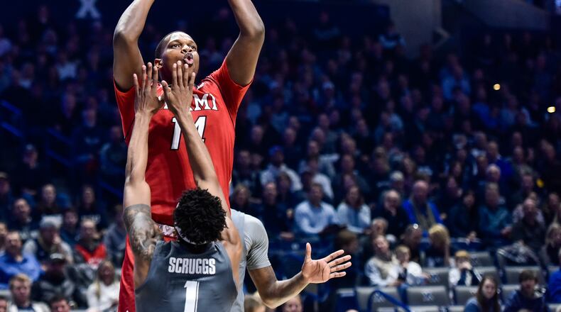 Miami’s Bam Bowman puts up a shot over Xavier’s Paul Scruggs during their basketball game Wednesday, Nov. 28 at Xavier’s Cintas Center in Cincinnati. Xavier won 82-55. NICK GRAHAM/STAFF