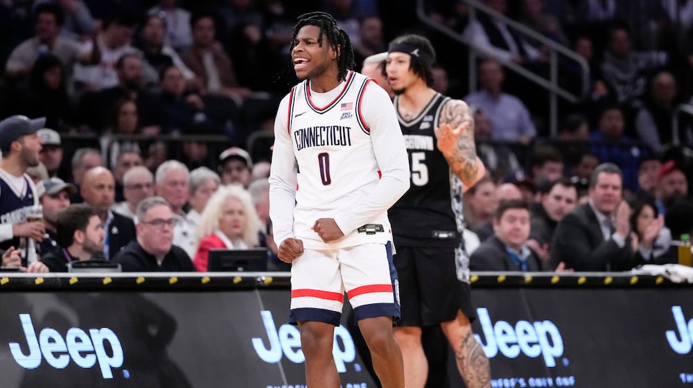 UConn guard Malachi Smith (0) reacts after stealing the ball during the first half of an NCAA college basketball game against Georgetown in the semifinals of the Big East tournament, Friday, March 13, 2026, in New York. (AP Photo/Yuki Iwamura)