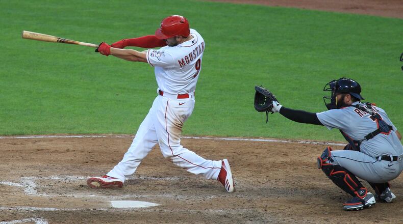 Mike Moustakas, of the Reds, hits a home run on Opening Day against the Tigers on Friday, July 24, 2020, at Great American Ball Park in Cincinnati.