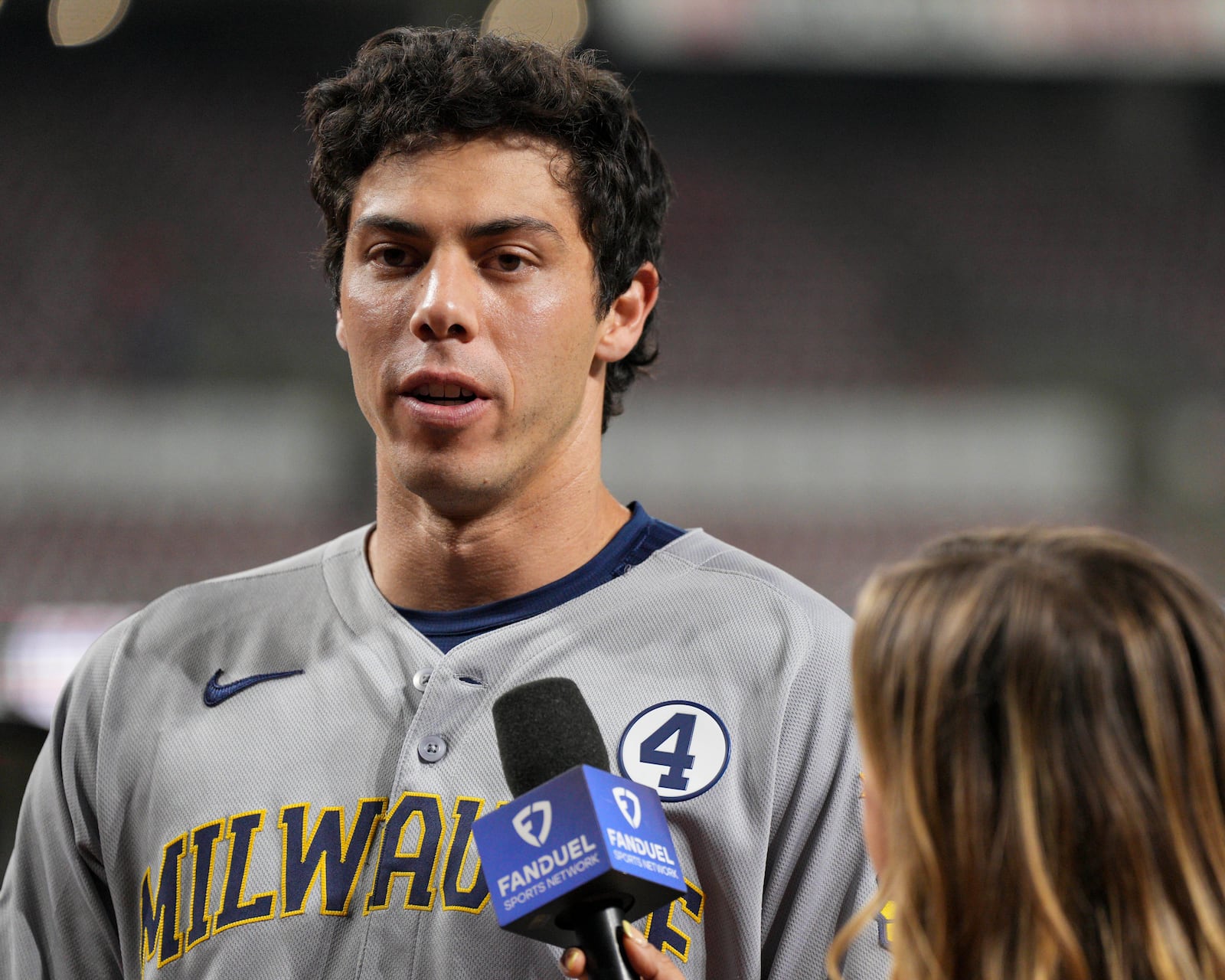 Milwaukee Brewers' Christian Yelich, left, is interviewed following a baseball game against the Cincinnati Reds, Monday, June 2, 2025, in Cincinnati. (AP Photo/Jeff Dean)