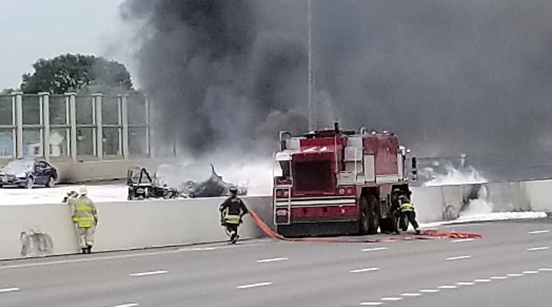 Wright-Patterson fire fighters assist Dayton first responders as they battle a major fuel fire on I-75 April 30 in Dayton. After using foam to combat the fire from the ARFF crash vehicle, Wright-Patterson fire fighters passed hoses to Dayton fire fighters to extinguish the remaining fire. (U.S. Air Force photo/Keith Hawkins)