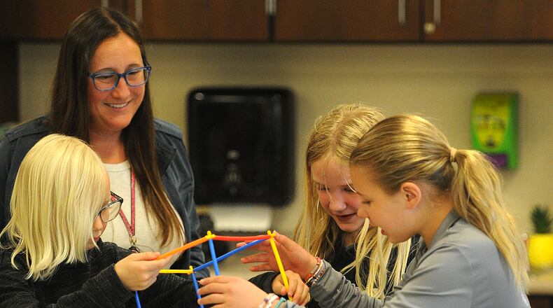 Miamisburg STEAM teacher Jessica Lay works with 4th grade students Wednesday, May 15, 2024 on a hands-on project, from left, Adelaide Tews, Emersyn Knox and Isabelle Cain. MARSHALL GORBY\STAFF