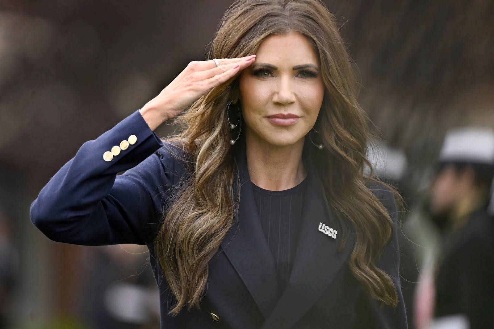 Homeland Security Secretary Kristi Noem salutes as she arrives at the commencement for the United States Coast Guard Academy, Wednesday, May 21, 2025 in New London, Conn. (AP Photo/Jessica Hill)