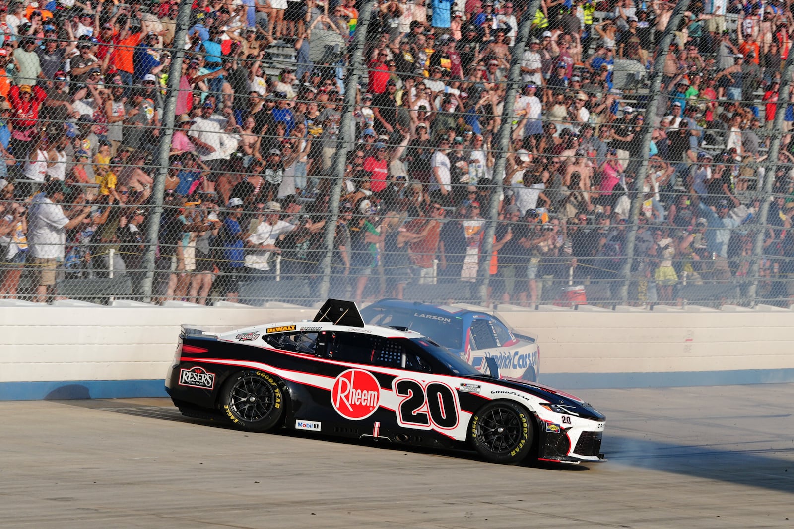 Christopher Bell (20) spins ahead of Kyle Larson (5) during a NASCAR Cup Series auto race at Dover Motor Speedway, Sunday, July 20, 2025, in Dover, Del. (AP Photo/Derik Hamilton)