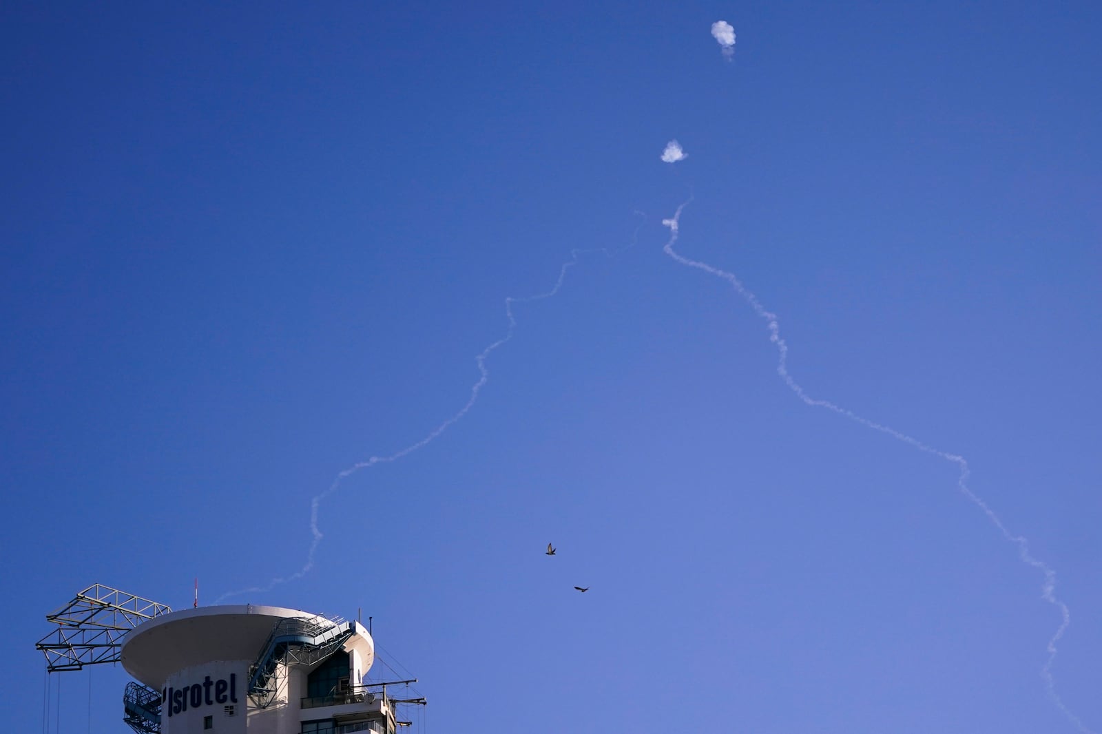 FILE - Israel's Iron Dome anti-missile system fires to intercept as air raid sirens sound in Tel Aviv, on Oct. 23, 2024. (Nathan Howard/Pool Photo via AP, File)