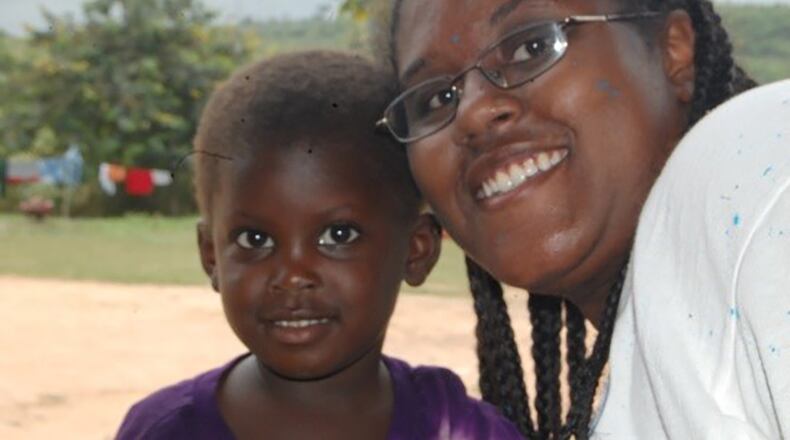 After painting outside of orphanage in Ghana, Africa, in 2008, Breanna McGowan poses with orphan Zahara. (Courtesy photo)