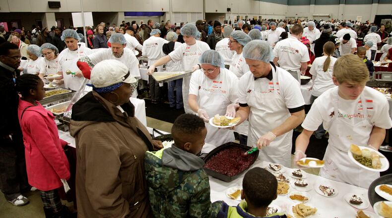 Thousands attended the Feast of Giving Thursday, an annual event held each Thanksgiving Day at the Dayton Convention Center. LISA POWELL / STAFF PHOTO