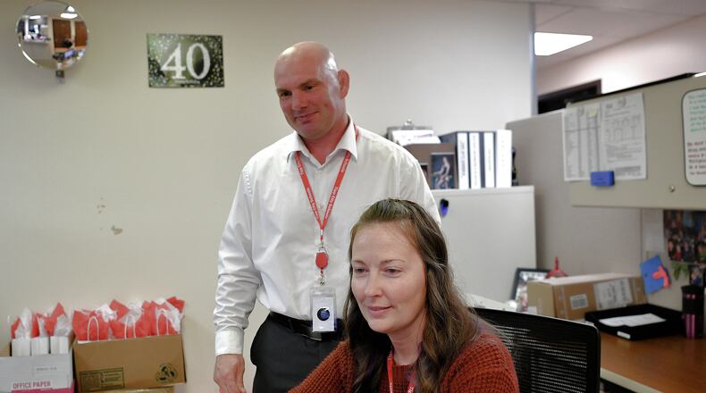 Aaron Moran (standing) is the incoming superintendent of the Tipp City Exempted Village Schools. He comes to the district after 11 years with the Versailles Local Schools. Pictured with Moran is Kristen Williams, executive assistant. CONTRIBUTED
