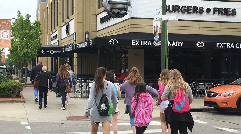 Shoppers walk through The Greene Town Center in Beavercreek. STAFF PHOTO