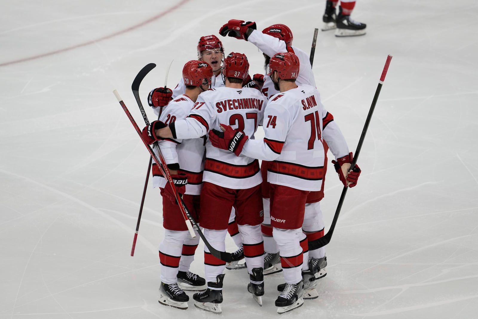 Carolina Hurricanes' Andrei Svechnikov (37), center, celebrates his goal with teammates during the first period of Game 4 of an NHL hockey first-round series against the New Jersey Devils, Sunday, April 27, 2025, in Newark, N.J. (AP Photo/Seth Wenig)
