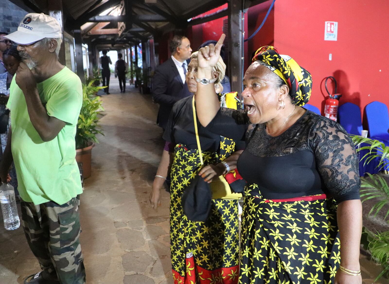 Angry residents argue after French President Emmanuel Macron' s visit Monday, April 21, 2025 in Mamoudzou, in the Indian Ocean French territory of Mayotte. (AP Photo/Alexis Duclos)