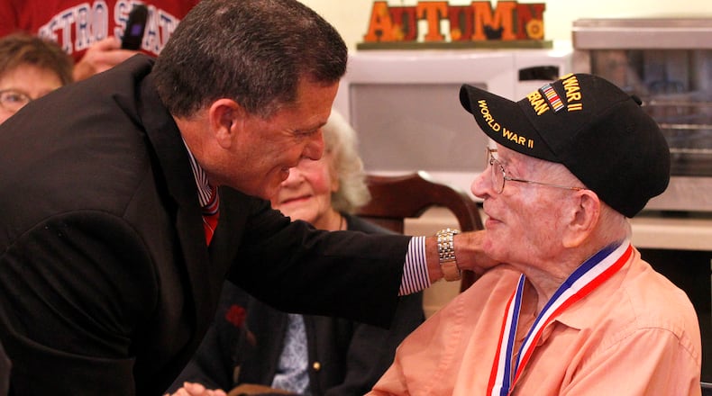 Charlie Burke, a World War II veteran and resident of Patriot Ridge Nursing Home in Fairborn, was  presented with a medallion minted in honor of veterans of  World War II. The Greene County Veterans Services Office and State Rep. Rick Perales, R-Beavercreek presented five World War II veterans with the medallions at a presentation at the nursing home Wednesday. The medallions were minted in honor and remembrance of veterans of WWII by the Non Commissioned Officers Association. The second annual veterans summit meeting in Greene County will be held tonight from 6-8 p.m. at 571 Ledbetter Rd. in Xenia. Representatives from veterans organizations, including the Dayton VA, will be on hand to answer veterans questions and make them aware of benefits they may not know about.  LISA POWELL / STAFF