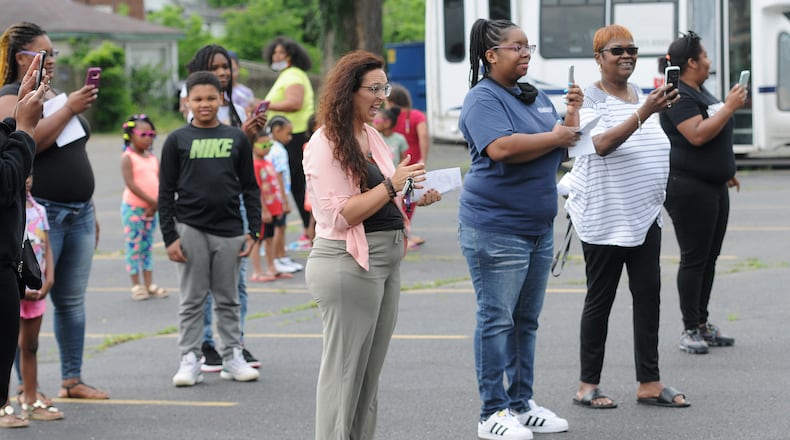 Parents and family members take photos Friday of the class of 2020 graduaton ceremony at the On Purpose Academy and Mentoring Center. MARSHALL GORBY\STAFF