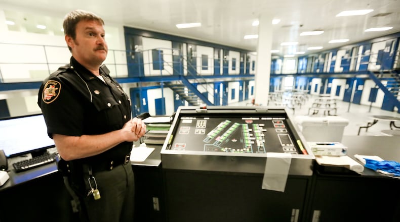 Butler County Corrections officer Richard Lane stands at the officers podium of Pod B of the Butler County Correctional Center, Thursday, Dec. 3, 2015. GREG LYNCH / STAFF