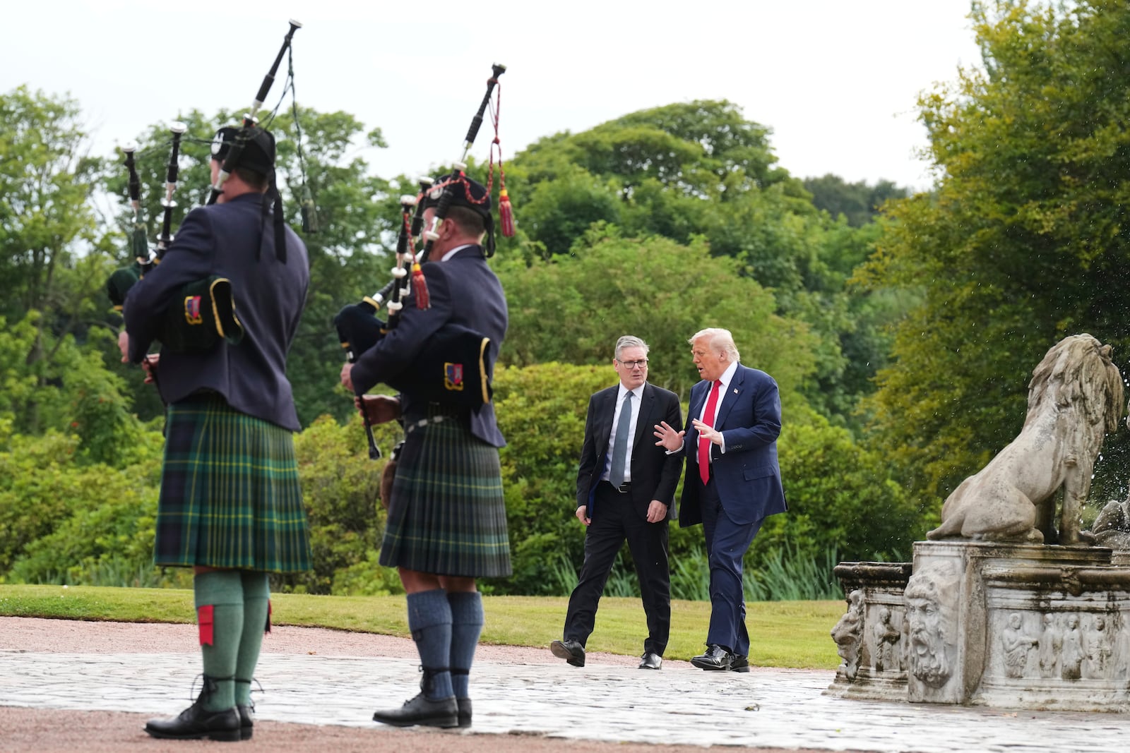 President Donald Trump, right, and Britain's Prime Minister Keir Starmer arrive at Trump International Golf Links, near Aberdeen, Scotland, Monday, July 28, 2025. (AP Photo/Jacquelyn Martin)