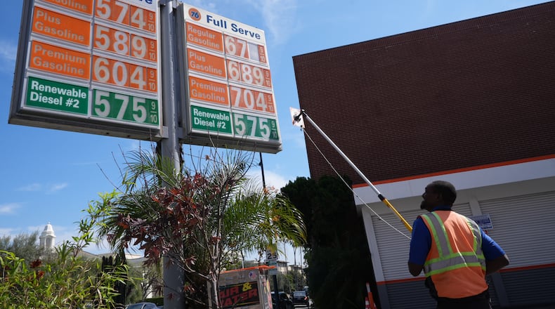 Gas prices are manually increased in Beverly Hills, Calif., Tuesday, March 3, 2026. (AP Photo/Damian Dovarganes)