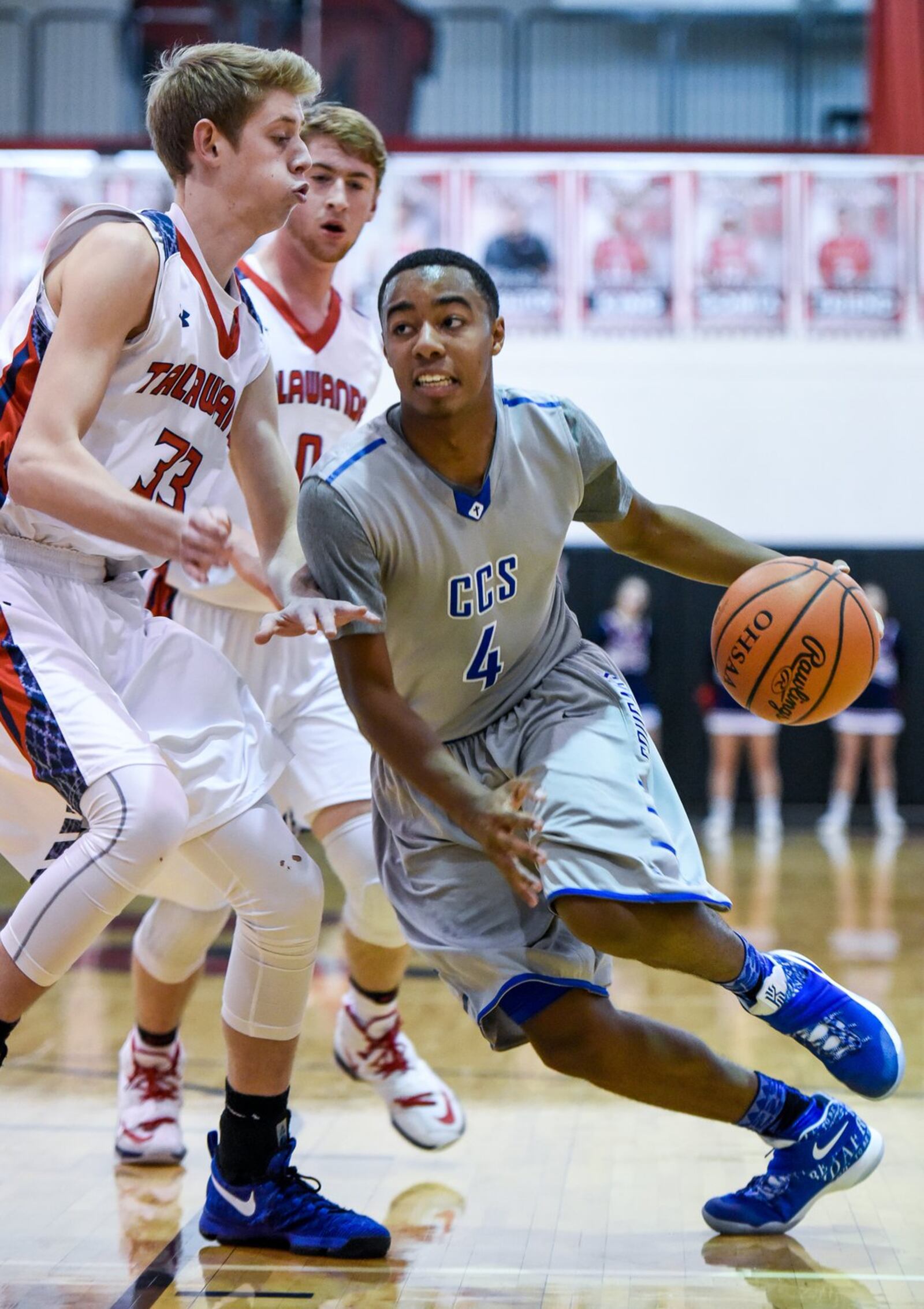 Cincinnati Christian’s Dylan Woods tries to dribble past Talawanda’s Josh DeWitt (33) and Evan James (0) on Thursday night during the Brian Cook Classic at Madison. NICK GRAHAM/STAFF