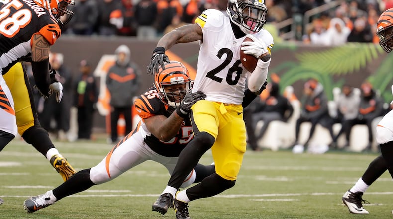 Vontaze Burfict #55 of the Cincinnati Bengals attempts to tackle Le’Veon Bell #26 of the Pittsburgh Steelers during the third quarter at Paul Brown Stadium on December 18, 2016 in Cincinnati, Ohio. (Photo by Andy Lyons/Getty Images)