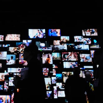 People walk past screens at the LG Electronics booth during the CES tech show Tuesday, Jan. 6, 2026, in Las Vegas. (AP Photo/Abbie Parr)