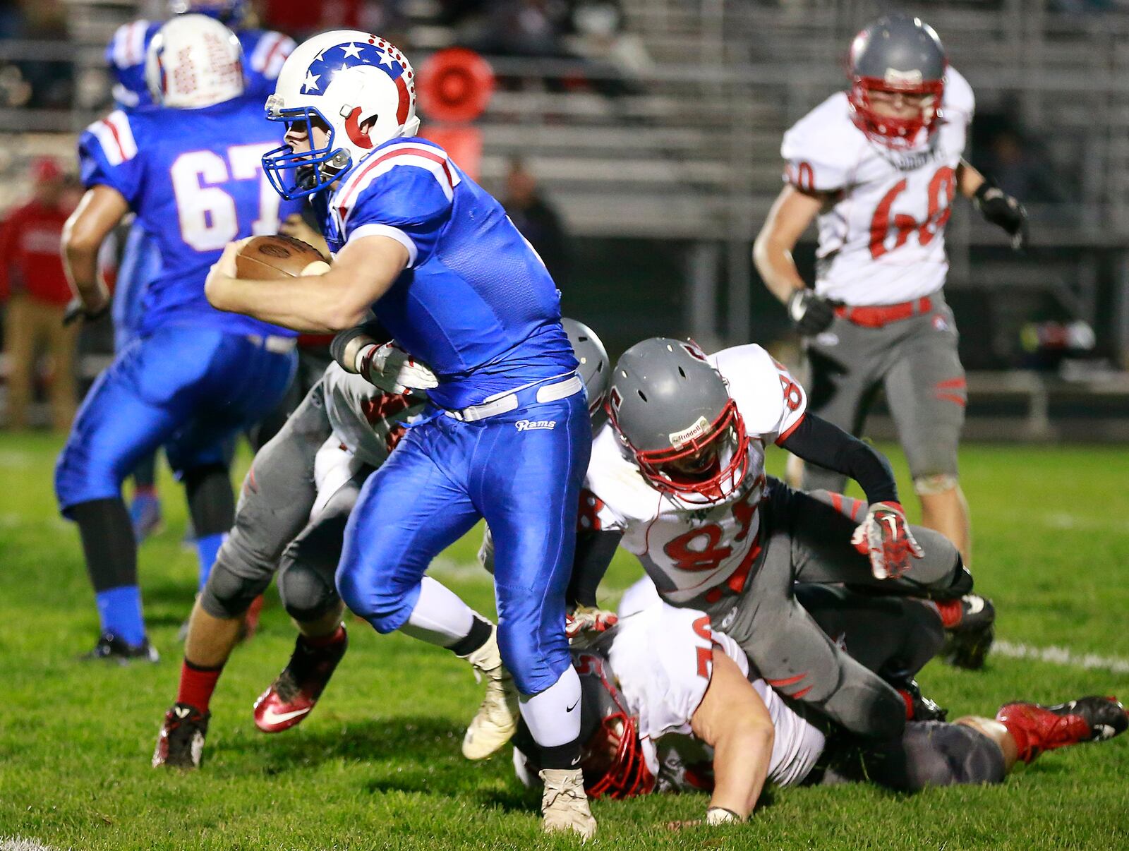 Greenevew’s Griffin Mangan breaks tackles by Southeastern’s Hayden Toops, Joe Sulfridge and Robbie Mills as he carries the ball. Bill Lackey/Staff
