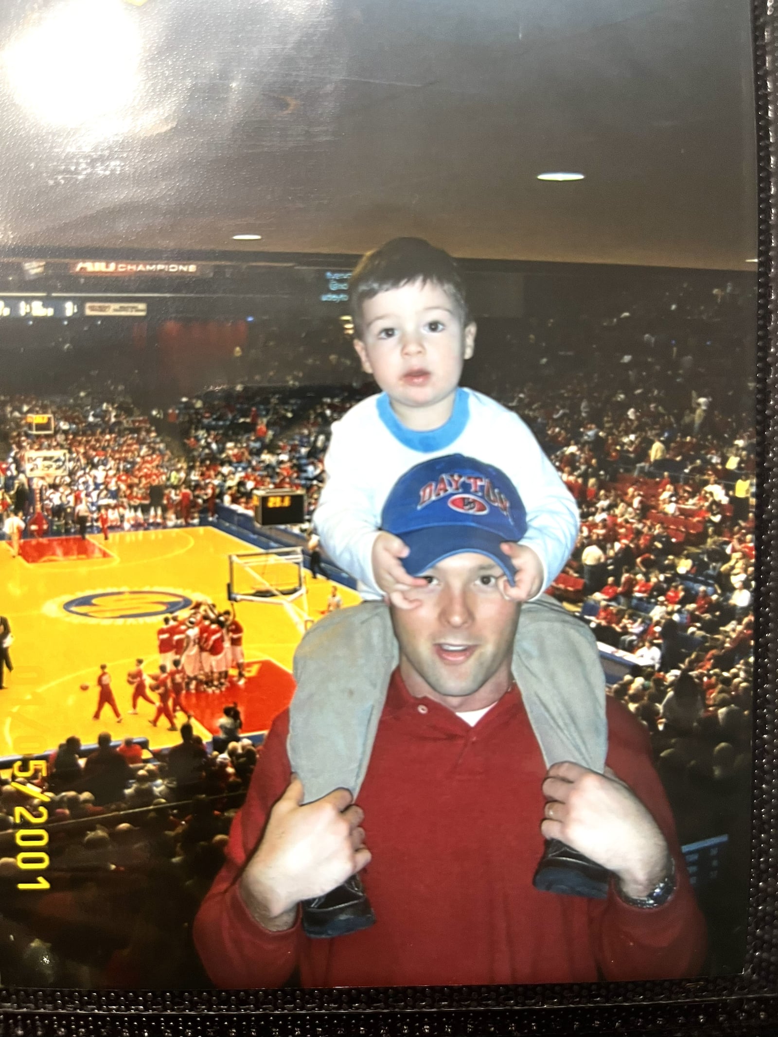 From  the time he was a little boy, Drew VanVleet, seen here on the shoulders of his dad Brad, was a regular at Dayton Flyers football and basketball games. They had basketball season tickets and at football games they sometimes stood on the Welcome Stadium sidelines and at halftime threw a football back and forth in the end zone. Drew’s dad was an All Pioneer League linebacker for the Flyers and his mom Kelly (Buer) played softball for UD. CONTRIBUTED PHOTO