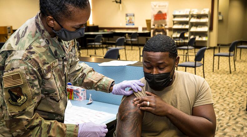 Senior Airman Rendall Powell, 412th Test Wing, receives a COVID-19 vaccination shot from Lt. Col. Yvonne Storey, 412th Medical Group, at the Airman and Family Readiness Center on Edwards Air Force Base, California, Aug. 25. U.S. AIR FORCE PHOTO/KATHERINE FRANCO