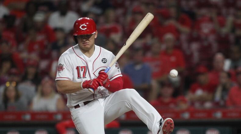 The Reds’ Josh VanMeter is hit by a pitch against the Astros on Tuesday, June 18, 2019, at Great American Ball Park in Cincinnati. David Jablonski/Staff