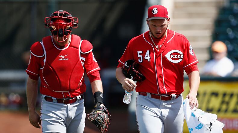 Cincinnati Reds pitcher Rookie Davis (54) walks in from the bullpen after warming up with catcher Devin Mesoraco, left, prior to the team’s spring training baseball game against the Kansas City Royals Monday, March 20, 2017, in Surprise, Ariz. (AP Photo/Ross D. Franklin)