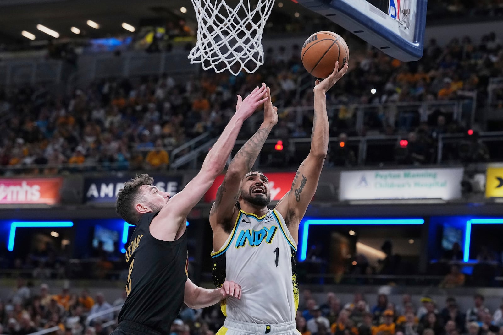 Indiana Pacers forward Obi Toppin (1) goes to the basket against Cleveland Cavaliers guard Ty Jerome in the second half of Game 4 in the Eastern Conference semifinals of the NBA basketball playoffs in Indianapolis, Sunday, May 11, 2025. (AP Photo/Michael Conroy)