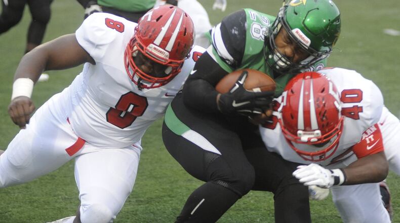Northmont’s Devin Kenerly (with ball) is met by Fairfield’s Greg Fitzpatrick (left) and Nashon Bell. Northmont defeated visiting Fairfield 28-21 in a Week 2 high school football game on Friday, Sept. 1, 2017. MARC PENDLETON / STAFF