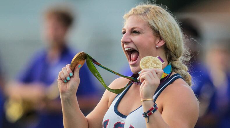 Kayla Harrison, two-time Olympic Gold Medalist in Judo, takes the field with her gold medals before the Middies game Friday, Sept. 9 at Barnitz Stadium in Middletown. NICK GRAHAM/STAFF