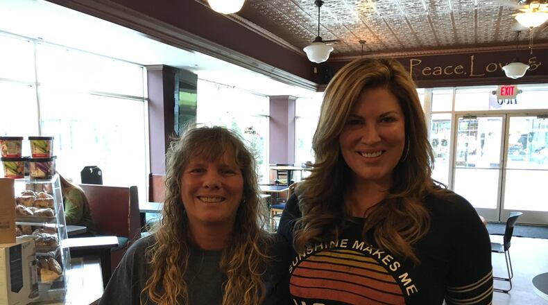 Heather Gibson of the Triple Moon Coffee Company poses with Emily Simpson, right, of “The Real Housewives of Orange County” reality show recently at the Triple Moon Coffee Company. A native of Madison Twp., Simpson returns to the area to visit friends and family. ED RICHTER/STAFF