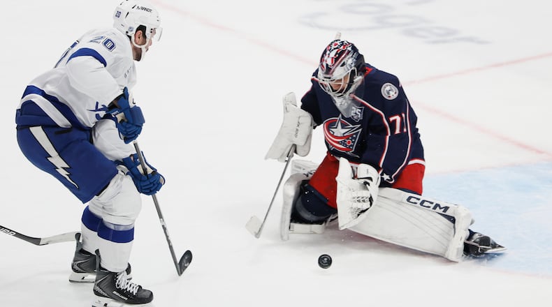 Columbus Blue Jackets' Jet Greaves, right, makes a save against Tampa Bay Lightning's Nick Paul, left, during the second period of an NHL hockey game, Saturday, Jan. 24, 2026, in Columbus, Ohio. (AP Photo/Jay LaPrete)