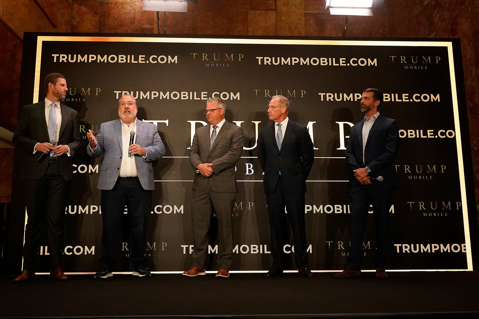 Eric Trump, Don Hendrickson, Eric Thomas, Patrick O'Brien and Donald Trump Jr., left to right, participate in the announcement of Trump Mobile, in New York's Trump Tower, Monday, June 16, 2025. (AP Photo/Richard Drew)