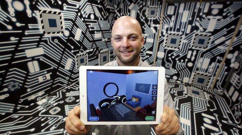 Barry Besecker, Marxent co-founder and chief technology officer, shows an example of the company’s mobile technology in this file photo. TY GREENLEES/STAFF