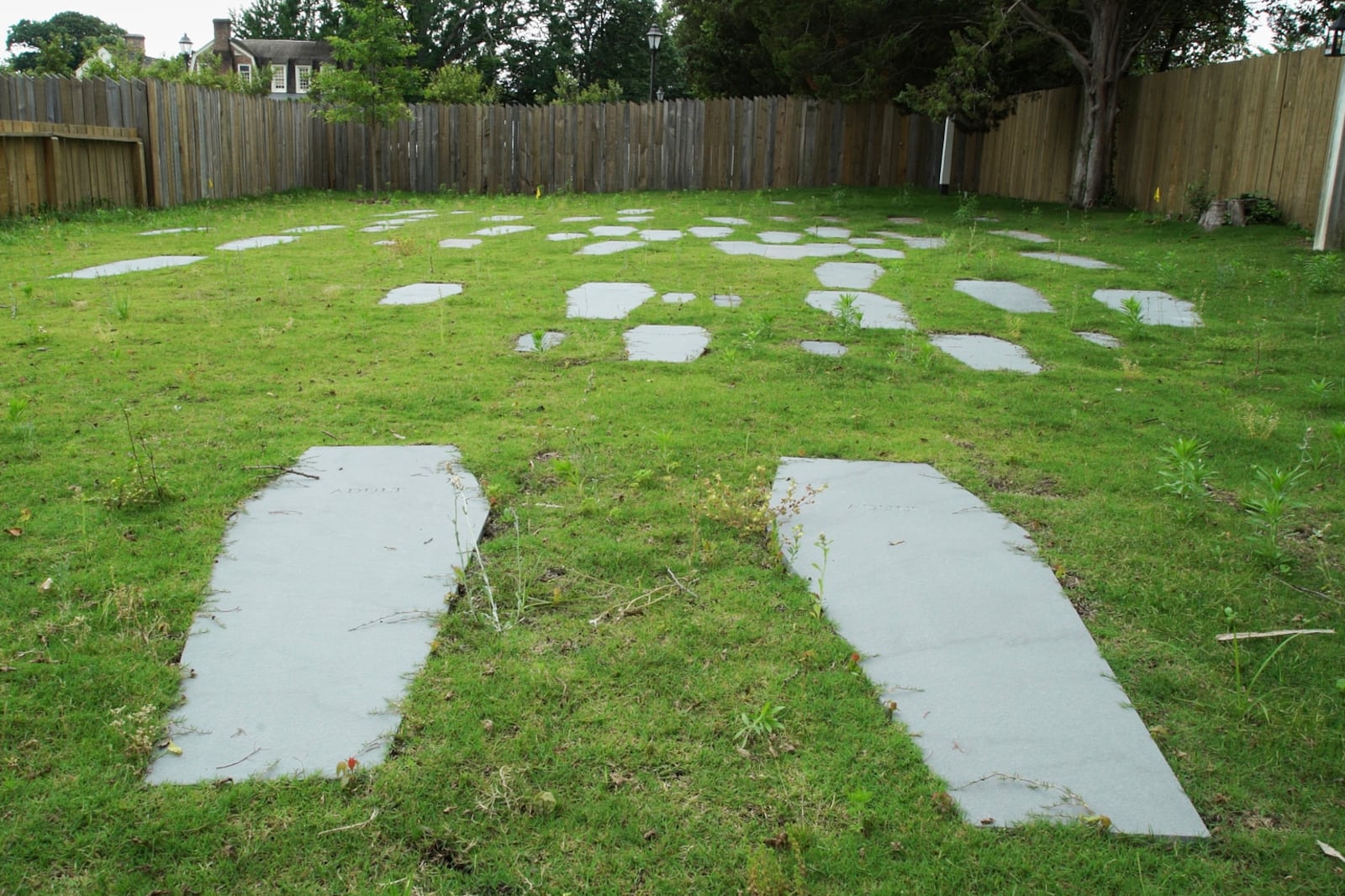 Casket-shaped stones mark the 62 graves identified at the original site of the First Baptist Church of Williamsburg in Williamsburg, Va., on May 30, 2025. (AP Photo/Allen G. Breed)
