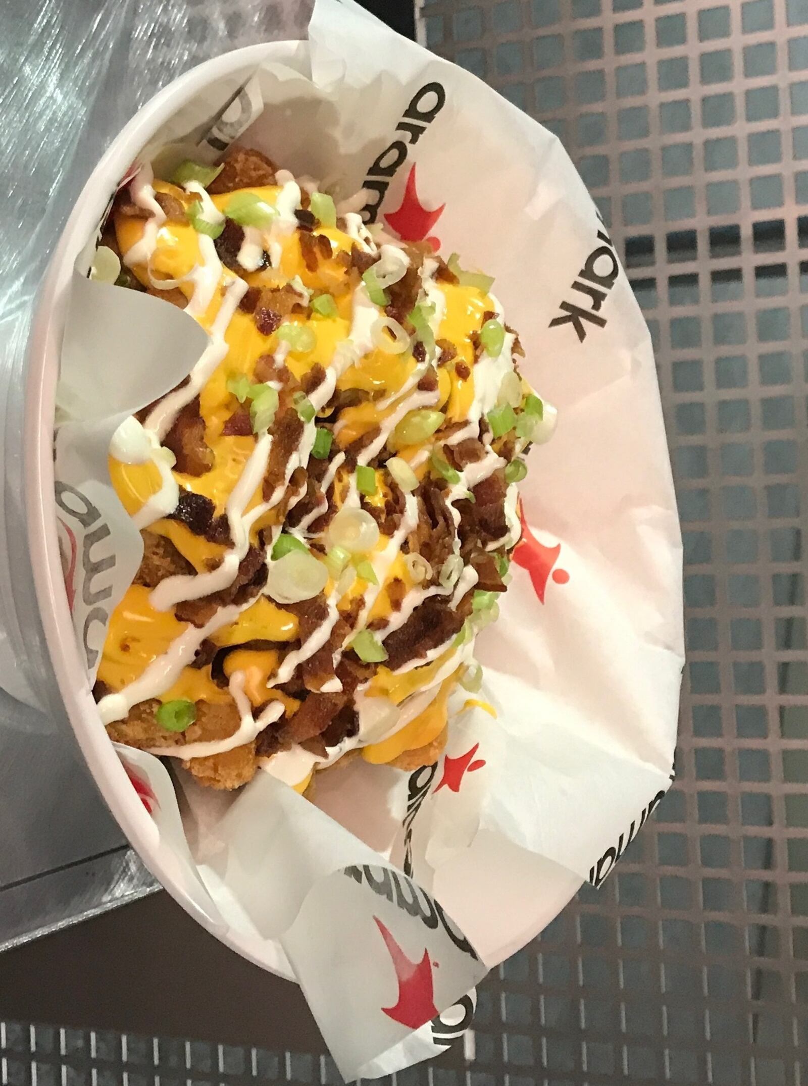 The Loaded Tator Tot with nacho cheese, bacon crumbles, sour cream and green onions is a new addition to the menu at Paul Brown Stadium, home of the Cincinnati Bengals, this season. AARON EPPLE/CONTRIBUTED