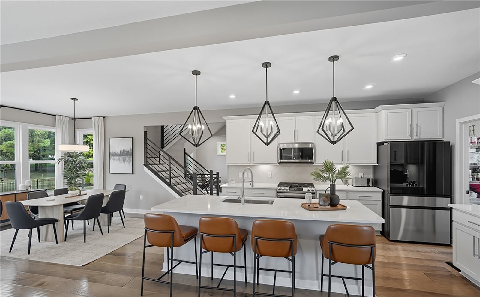 The open concept kitchen and dining room area has hardwood flooring, an island with a breakfast bar, separate dining area and walk in pantry. CONTRIBUTED
