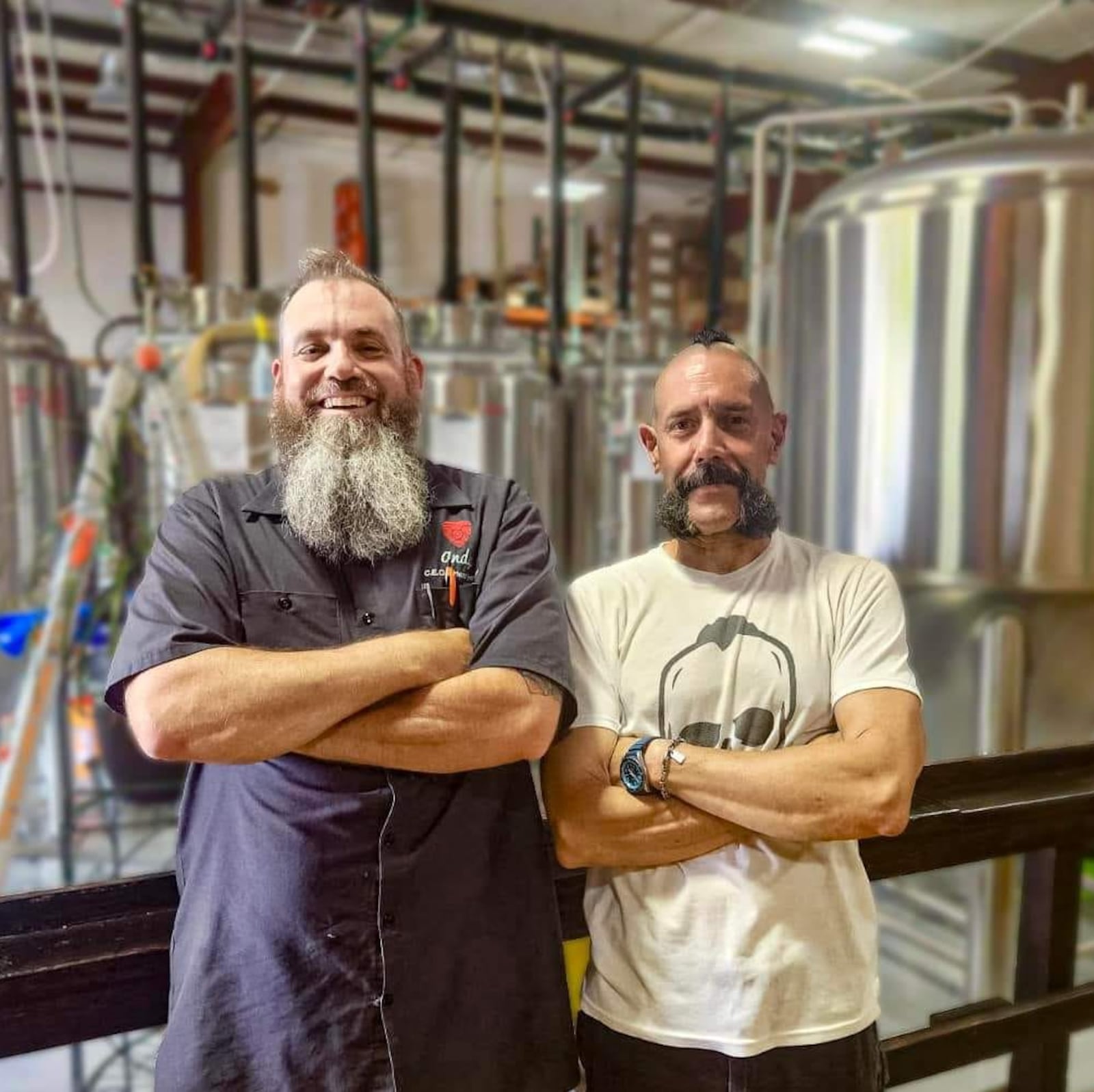 Alexandria Brewing Company's owner, Andy Reynolds, left, poses with Bender's Pub Grub Chef Shawn Weinbender, right. Reynolds is a co-owner of an outpost of Alexandria Brewing Company that is opening in West Chester Twp., Ohio. CONTRIBUTED