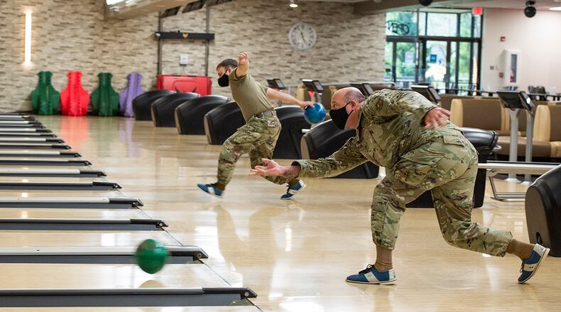 Col. Patrick Miller (right), 88th Air Base Wing and installation commander, rolls a ball down the lane during the Eagles vs. Chiefs Bowling Challenge at Wright-Patterson Air Force Base. U.S. AIR FORCE PHOTO/FARNSWORTH