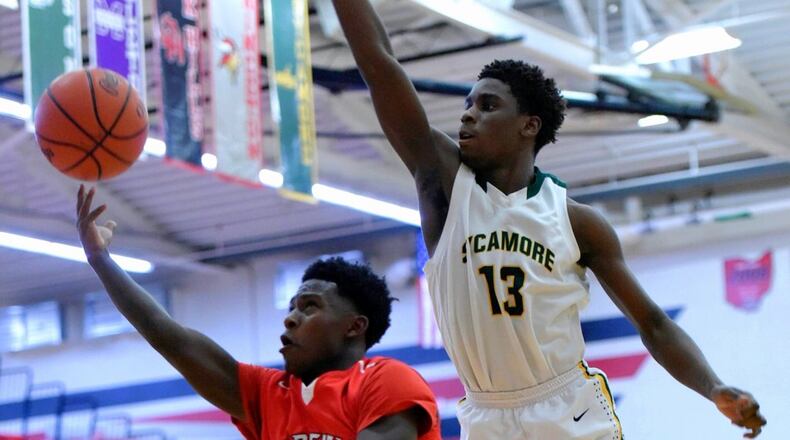 Fairfield’s Raqwon Williams drives to the hoop defended by Sycamore’s Khadim Fall during their Division I sectional game Feb. 24 at Lakota West. NICK GRAHAM/STAFF