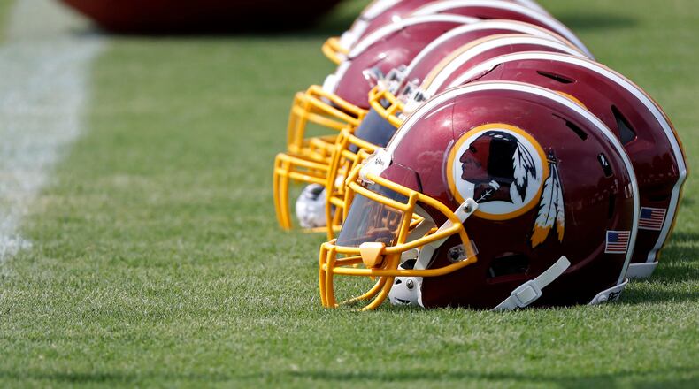Washington Redskins players' helmets rest on the field during training camp.