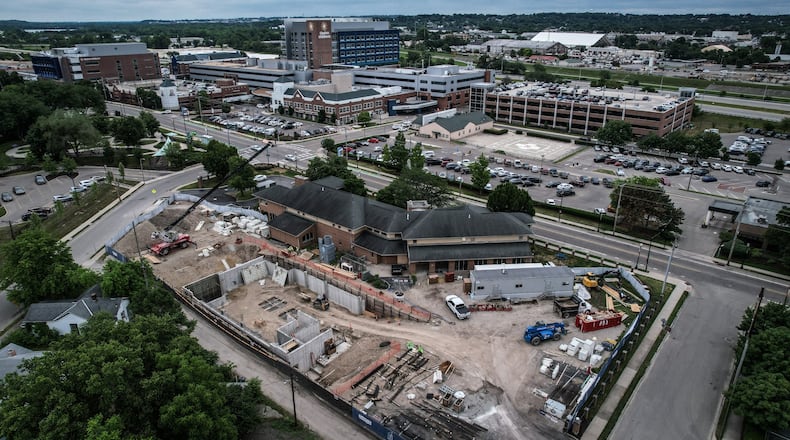 In the foreground, the Ronald McDonald House expansion on Valley Street across from Dayton Children's Hospital continues to progress. The $29 million lodging facility for families of hospitalized children will triple its original size. JIM NOELKER/STAFF