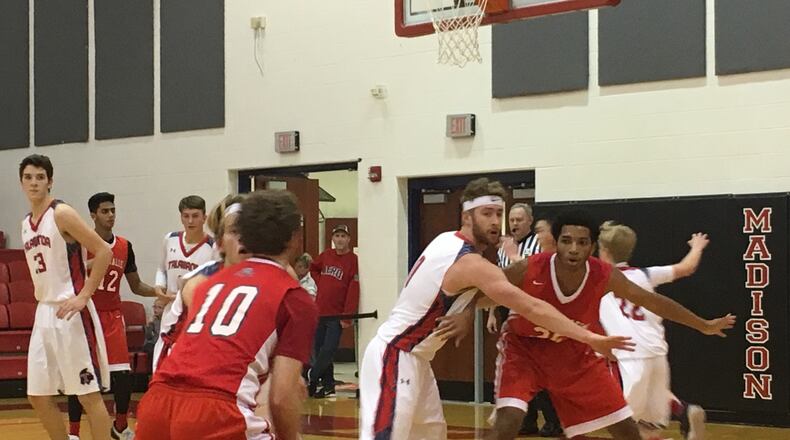Talawanda’s Evan James defends Miami Valley’s Marc Williams as Alec Martin (10) looks to make a pass Thursday night, Dec. 28, 2017, during the Brian Cook Classic at Madison. Talawanda advanced with a 51-48 victory. RICK CASSANO/STAFF