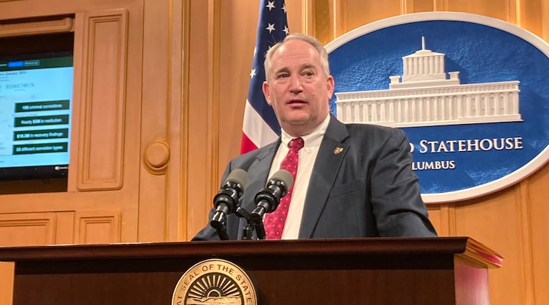 Republican Ohio Auditor Keith Faber marks the 100th conviction for fraud and corruption by his office since 2019 at a Thursday, Feb. 2, 2023, news conference at the Ohio Statehouse in Columbus, Ohio. Faber called for increasing training for government employees on how to spot fraud and corruption and requiring them to speedily report suspected crimes, as a way of improving the state's ability to root out and prosecute bad actors and recoup taxpayer money. (AP Photo/Julie Carr Smyth)